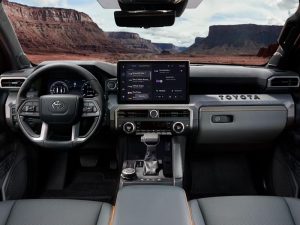 Toyota Tacoma interior showing steering wheel, dash and screen.