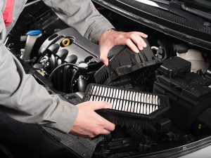 Service Technician removing the engine air filter.