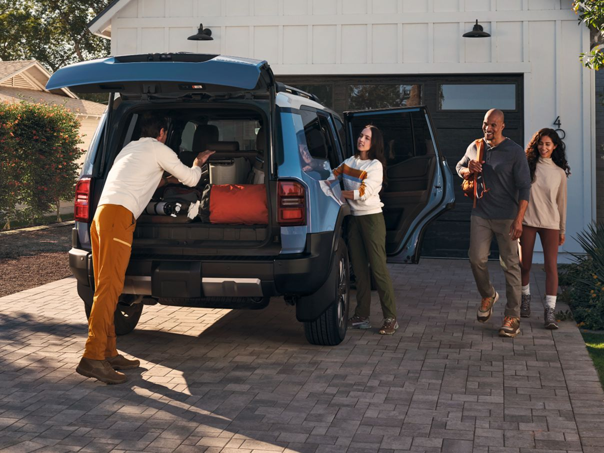 Happy family surrounding their new Toyota vehicle bought at Bell Road Toyota