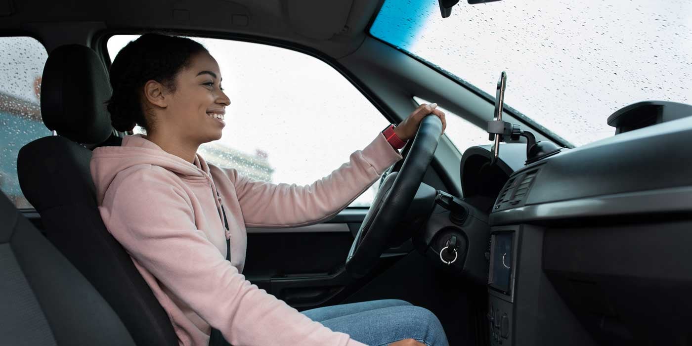 Quality pre-owned Toyota vehicle owner driving happily