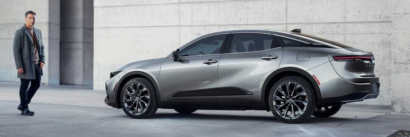 Man stadning next to a gray 2025 Toyota Crown