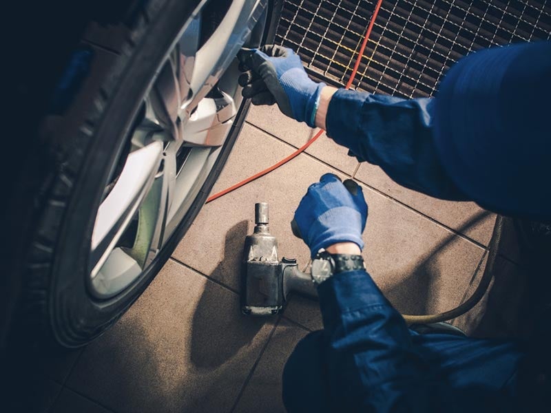 Mechanic inspecting tires.