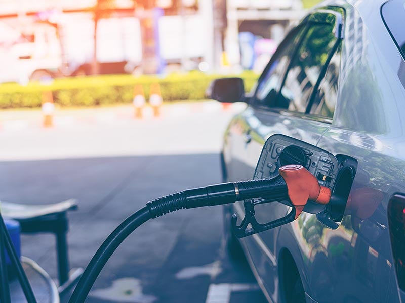 Car being fueled up at a gas station.
